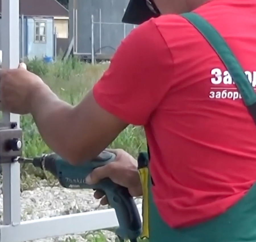 man-using-screwdriver-twists-metal-picket-fence-fence-worker-professional-construction-fencing-security-own-territory